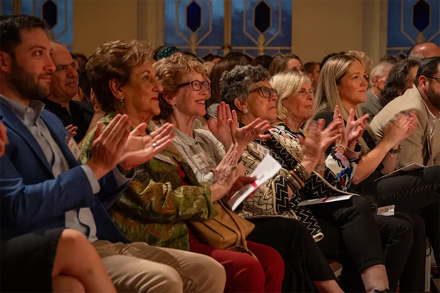 JWFA members in audience at an event clapping