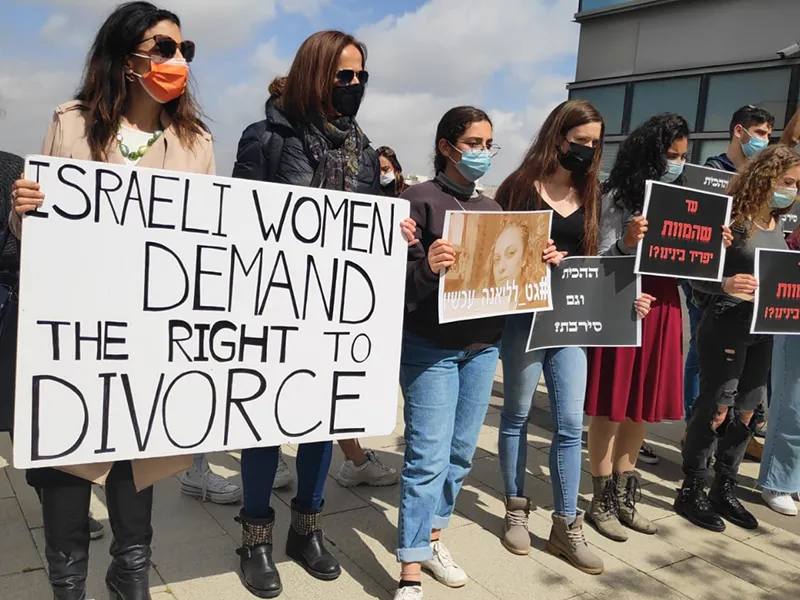 impact-grants-1 Women holding signs in protest
